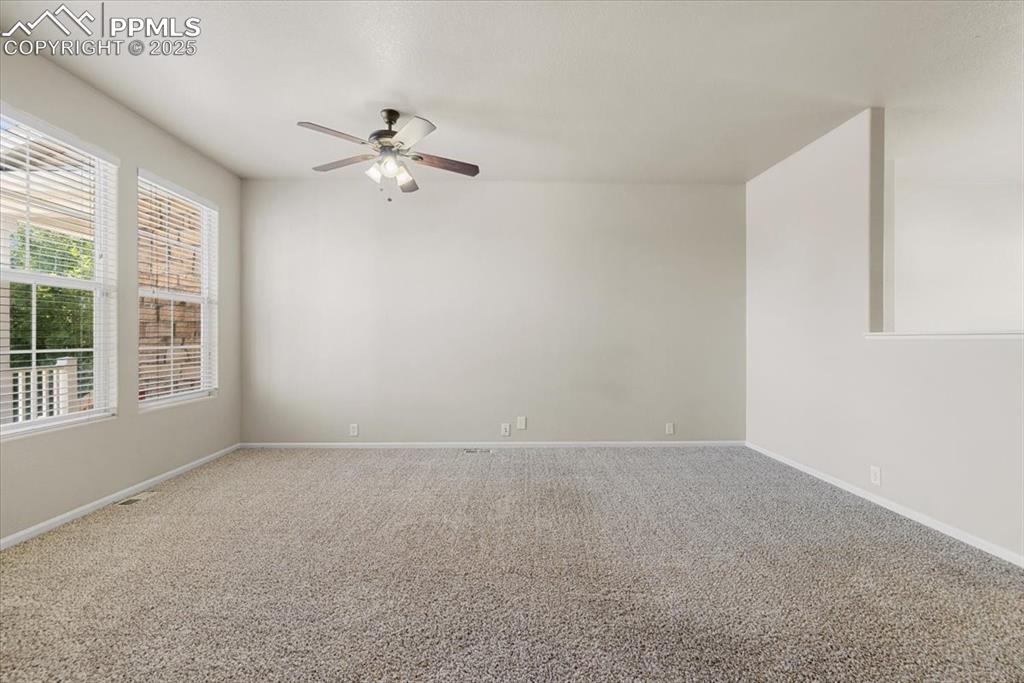 2740 Stonecrop Ridge Grove Colorado Springs, CO 80910 - Photo 7 of 42 Carpeted empty room featuring baseboards and a ceiling fan