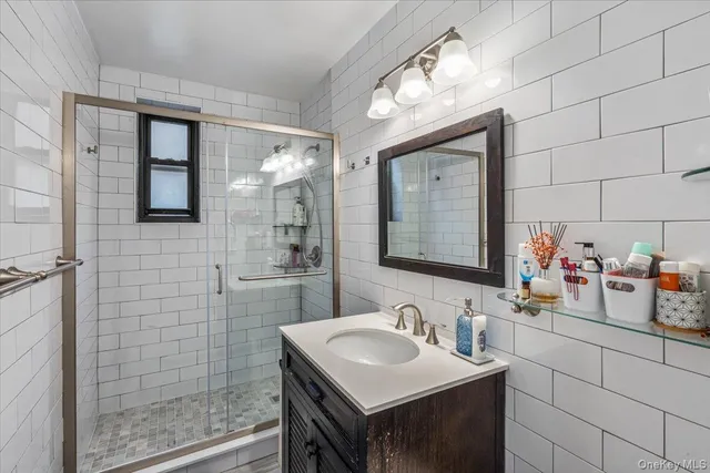 a bathroom with a sink vanity and a mirror