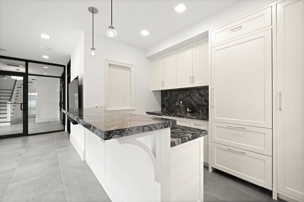 210 Monument Farm Road Concord, MA 01742 - Photo 33 of 42 a kitchen with stainless steel appliances granite countertop a refrigerator and a stove top oven
