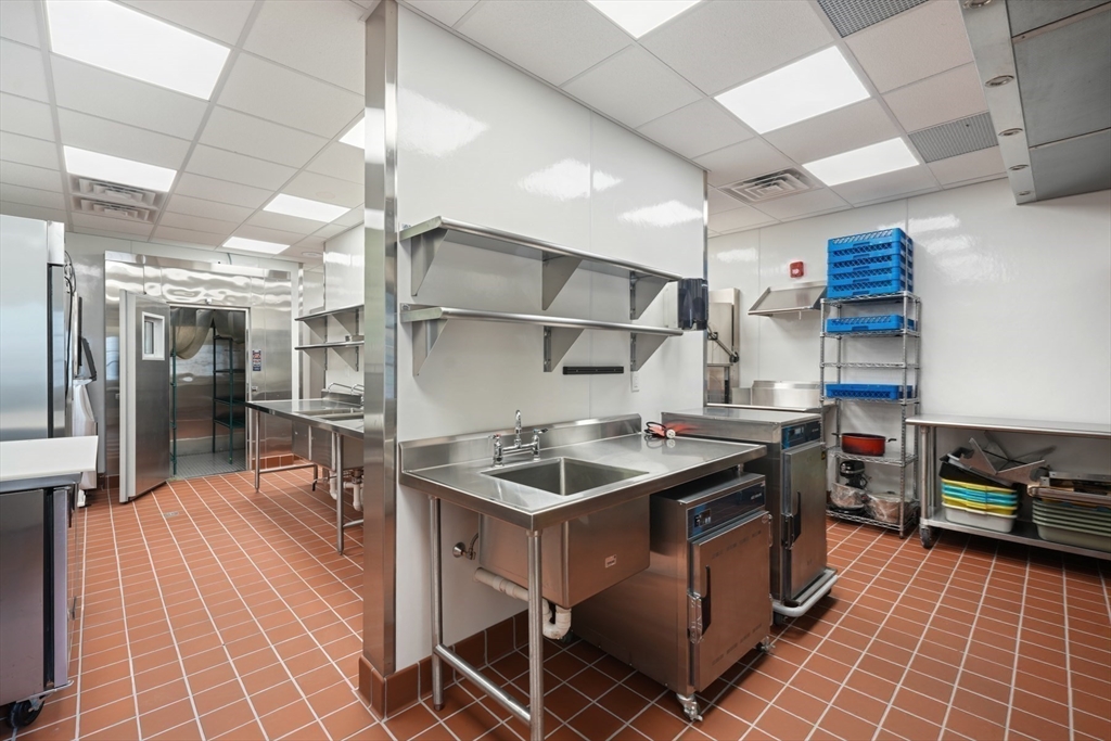 210 Monument Farm Road Concord, MA 01742 - Photo 35 of 42 a kitchen with stainless steel appliances granite countertop a sink and a cabinets