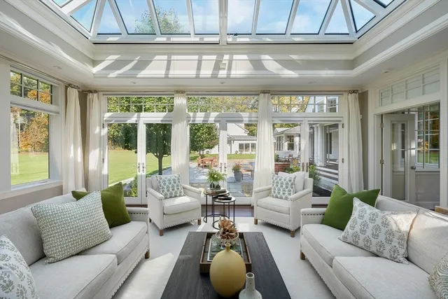 a living room with furniture and floor to ceiling windows