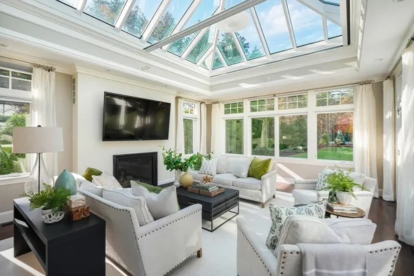 a living room with furniture a fireplace and a window