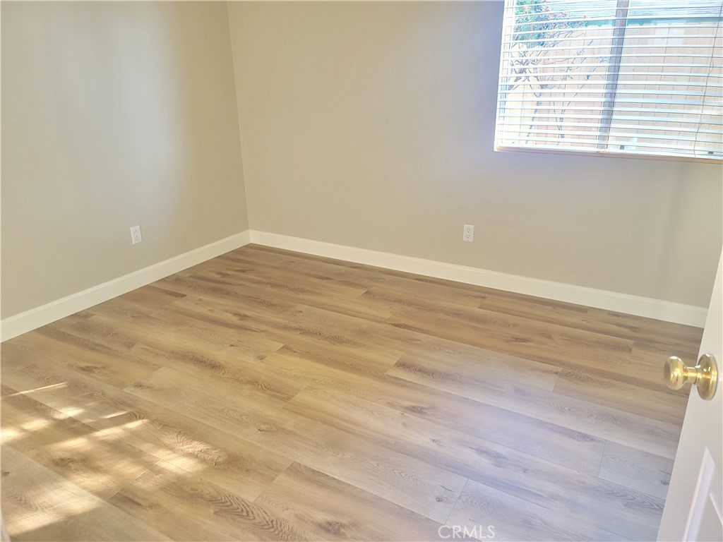 44915 Machon Road Temecula, CA 92592 - Photo 18 of 40 a view of an empty room with wooden floor and a window
