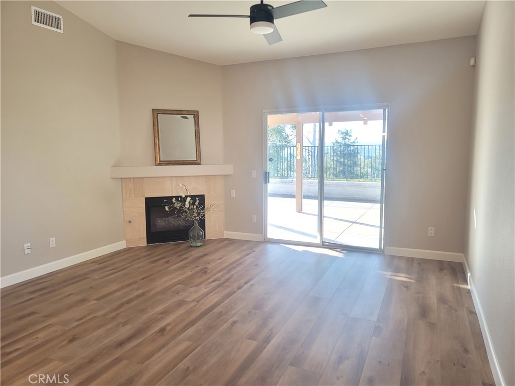 44915 Machon Road Temecula, CA 92592 - Photo 26 of 40 wooden floor fireplace and natural light in room
