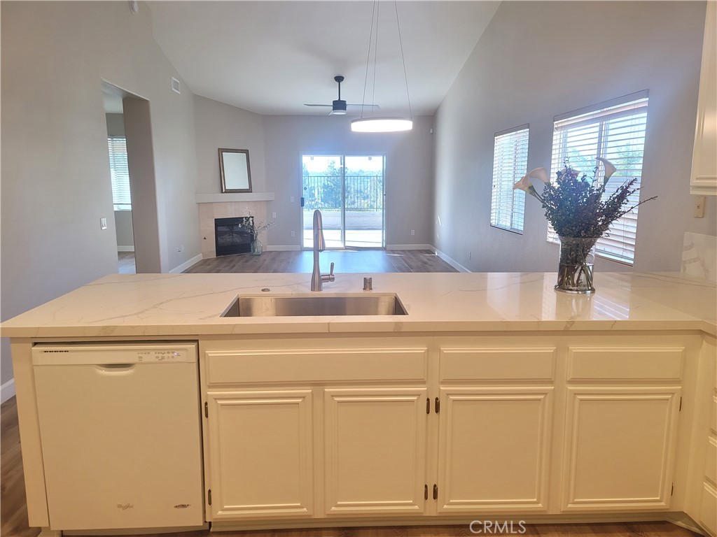 44915 Machon Road Temecula, CA 92592 - Photo 34 of 40 a view of a kitchen sink and dishwasher with wooden floor