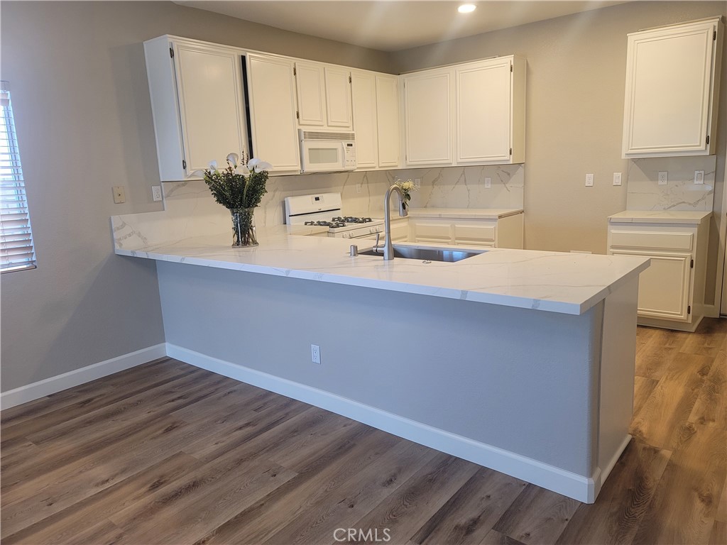 44915 Machon Road Temecula, CA 92592 - Photo 36 of 40 a kitchen with stainless steel appliances a sink window and cabinets