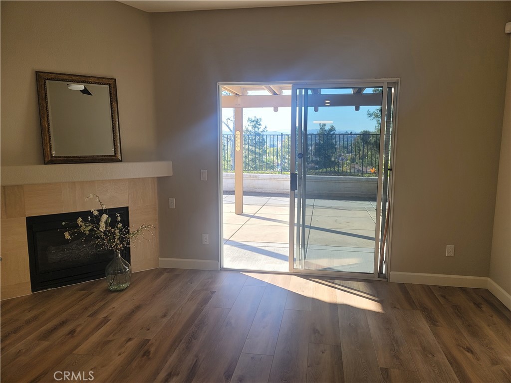 44915 Machon Road Temecula, CA 92592 - Photo 7 of 40 a living room with a fireplace and wooden floor