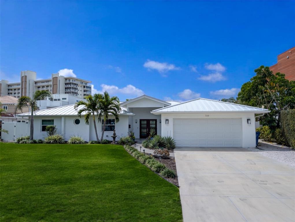 709 Valencia Road Venice, FL 34285 - Photo 1 of 1 a front view of a house with a garden and yard
