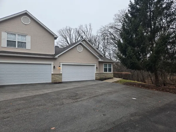 a view of a house with a yard and garage