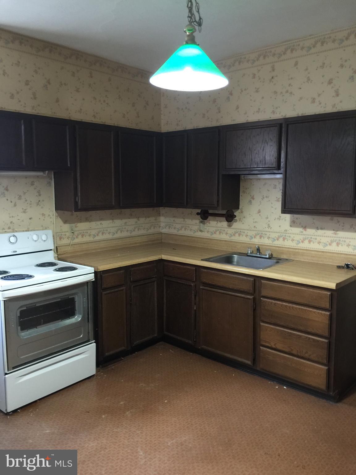 222 2nd Avenue Hanover, PA 17331 - Photo 2 of 10 a kitchen with granite countertop a stove a sink and a microwave