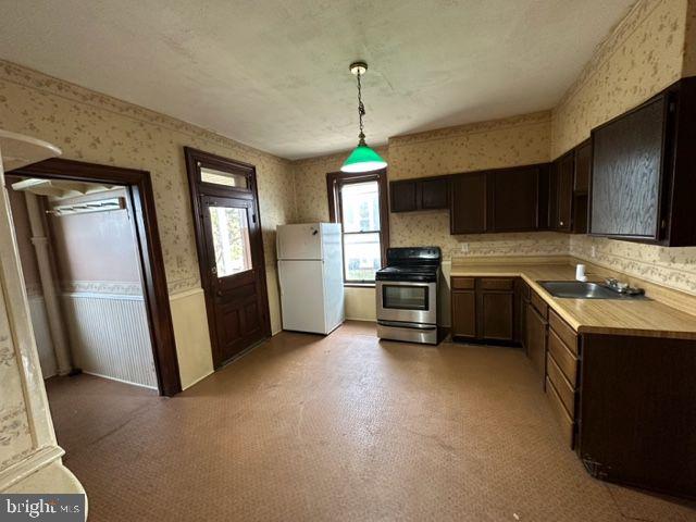 222 2nd Avenue Hanover, PA 17331 - Photo 7 of 10 a kitchen with stainless steel appliances granite countertop a refrigerator a sink dishwasher a stove top oven a refrigerator and cabinets
