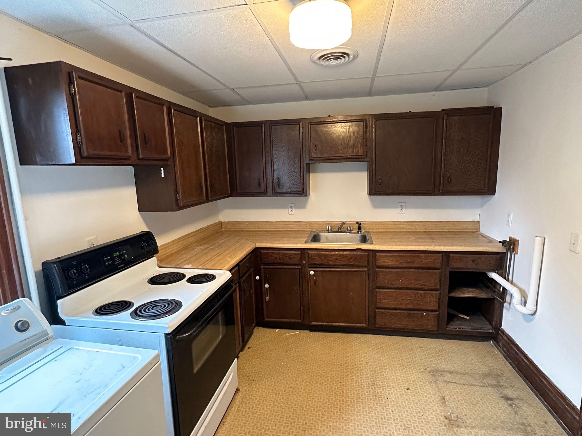 222 2nd Avenue Hanover, PA 17331 - Photo 10 of 10 a kitchen with wooden cabinets and a stove top oven
