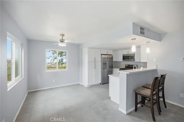 a kitchen with stainless steel appliances a refrigerator and a stove top oven