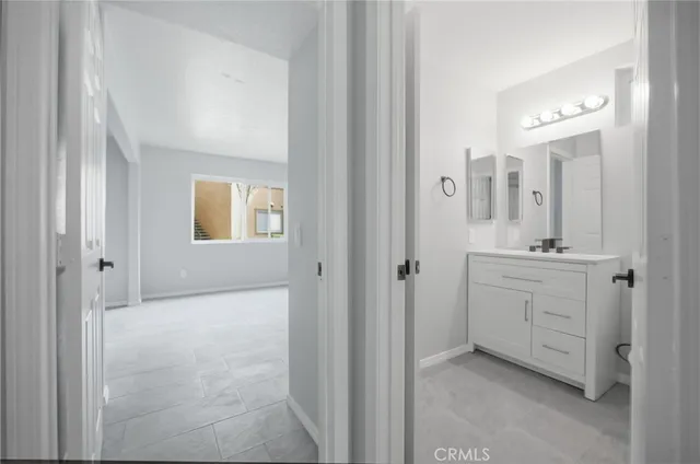 a bathroom with a sink a mirror and a vanity