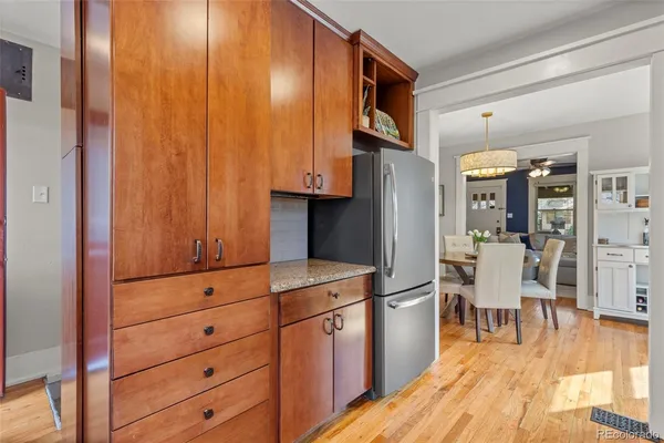 a view of a kitchen with refrigerator and cabinets