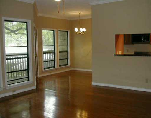 1406 Windsor Road, Unit 201 Austin, TX 78703 - Photo 1 of 1 a view of an empty room with wooden floor and a window