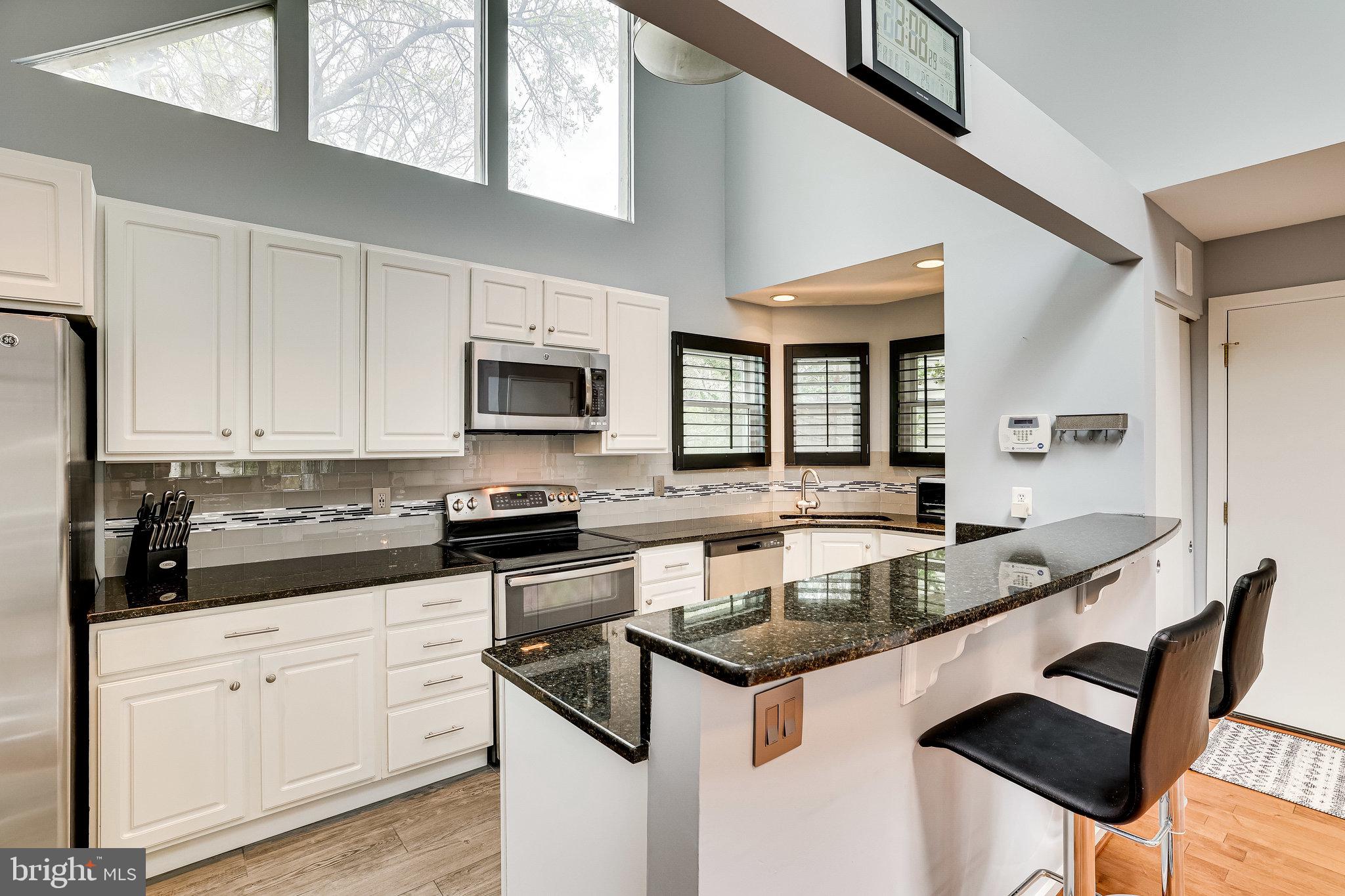 1657 Cedar Hollow Way Reston, VA 20194 - Photo 12 of 36 Black granite with clean white cabinets