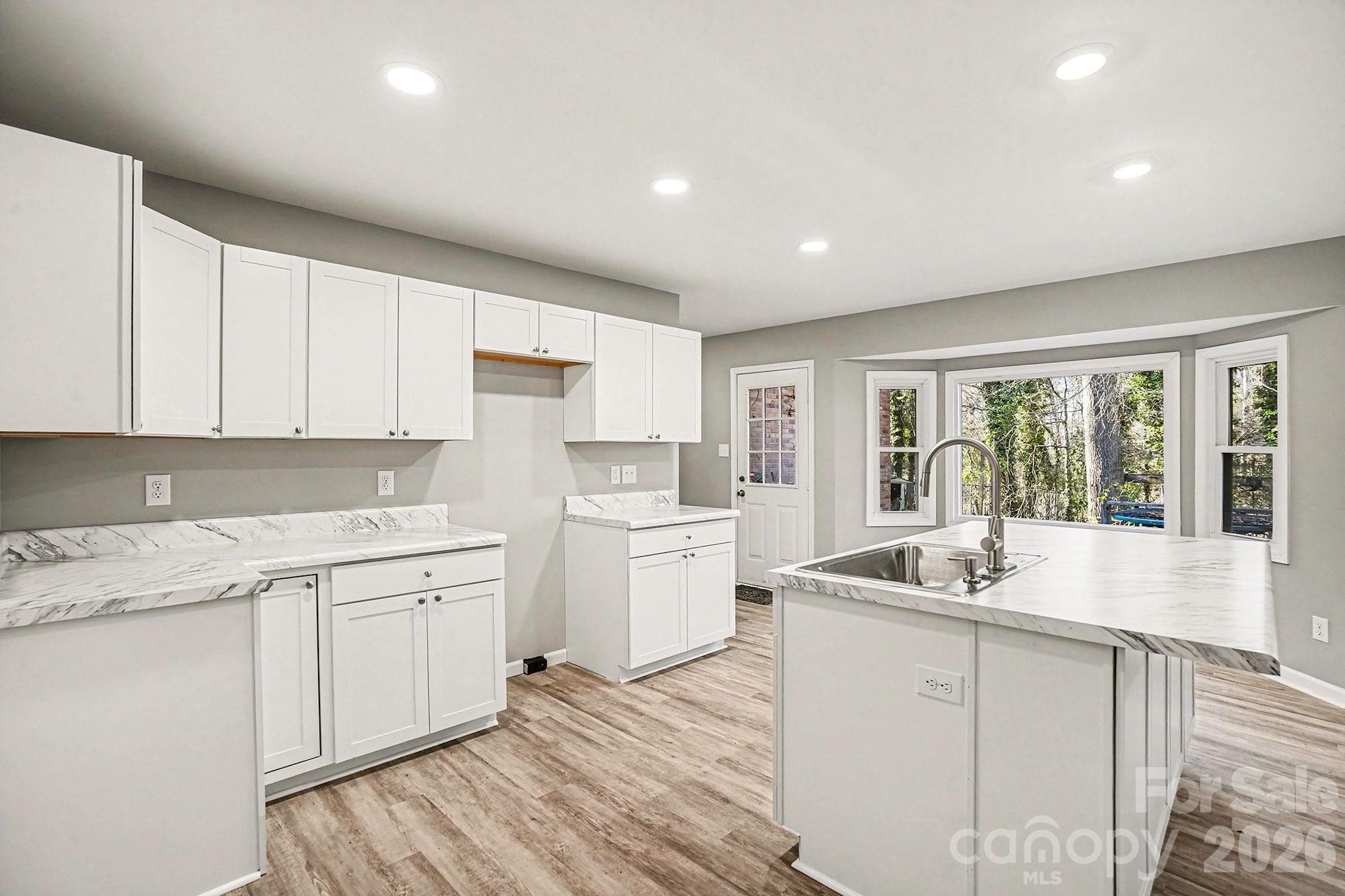 5509 Morgan Mill Road Monroe, NC 28110 - Photo 11 of 33 a kitchen with a sink stove and cabinets