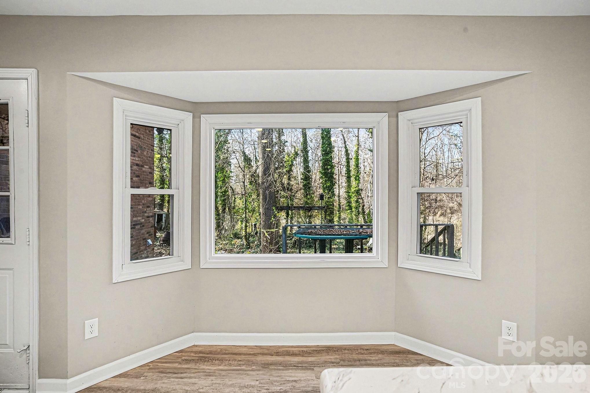 5509 Morgan Mill Road Monroe, NC 28110 - Photo 12 of 33 a view of an empty room with a window and wooden floor