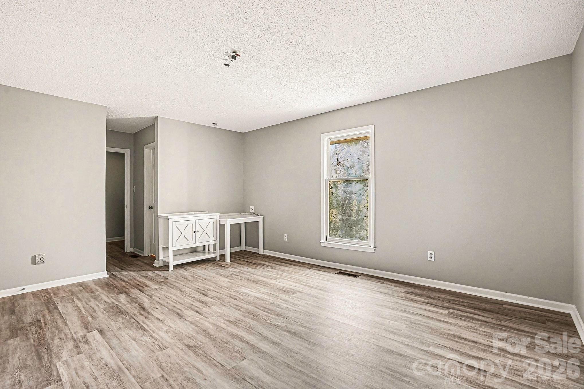 5509 Morgan Mill Road Monroe, NC 28110 - Photo 15 of 33 an empty room with wooden floor and windows
