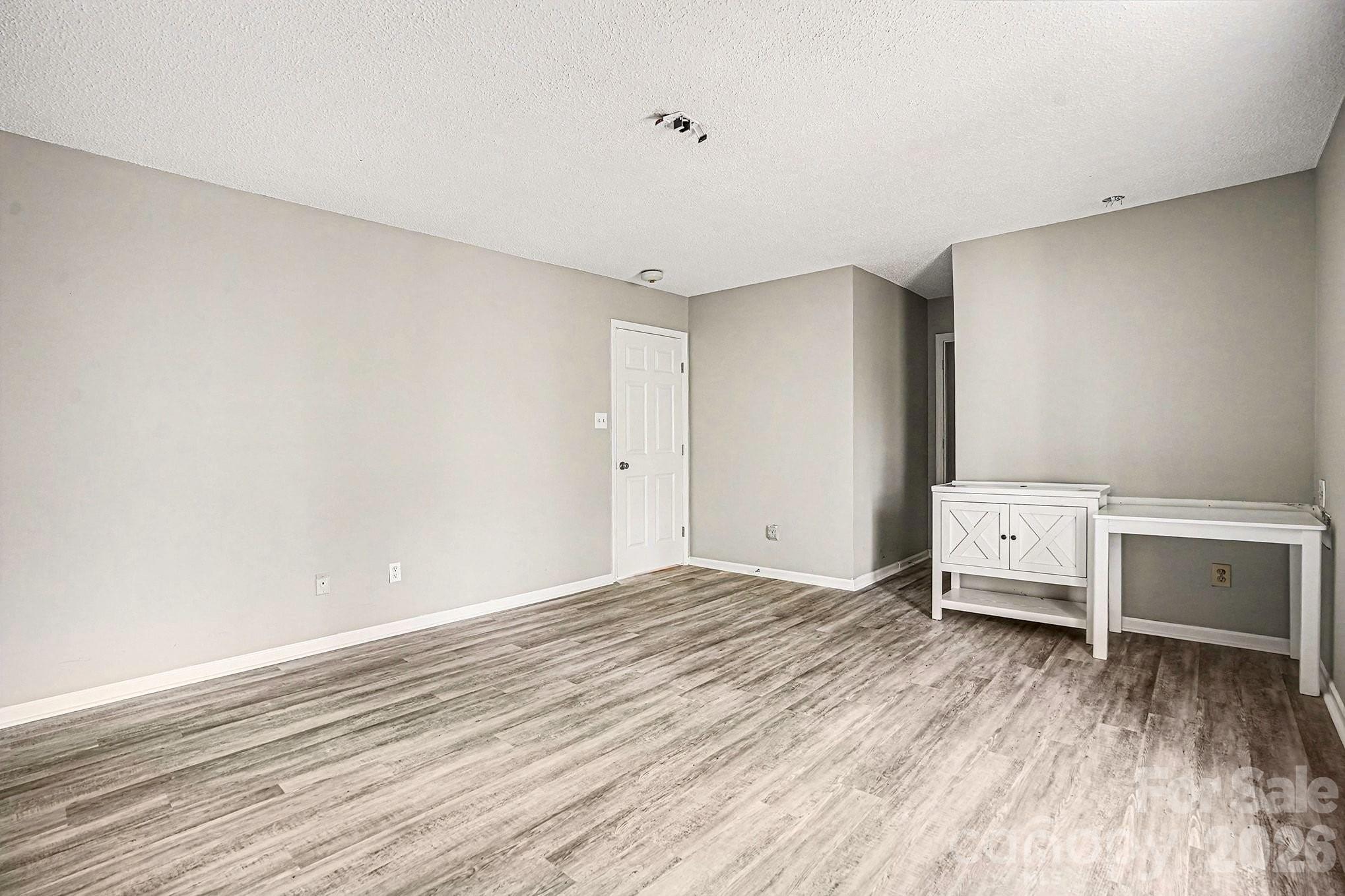 5509 Morgan Mill Road Monroe, NC 28110 - Photo 16 of 33 a view of a room with wooden floor
