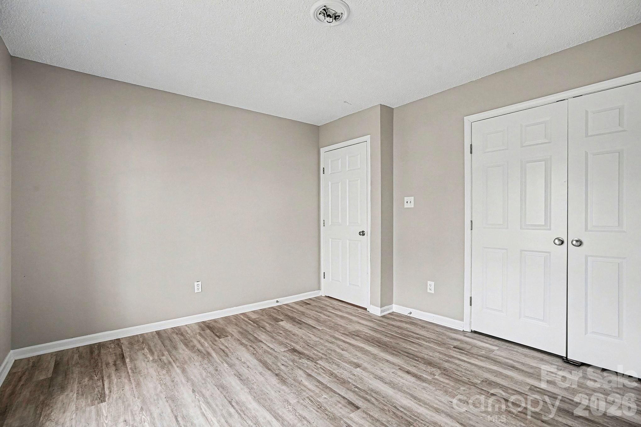 5509 Morgan Mill Road Monroe, NC 28110 - Photo 23 of 33 a view of an empty room and wooden floor