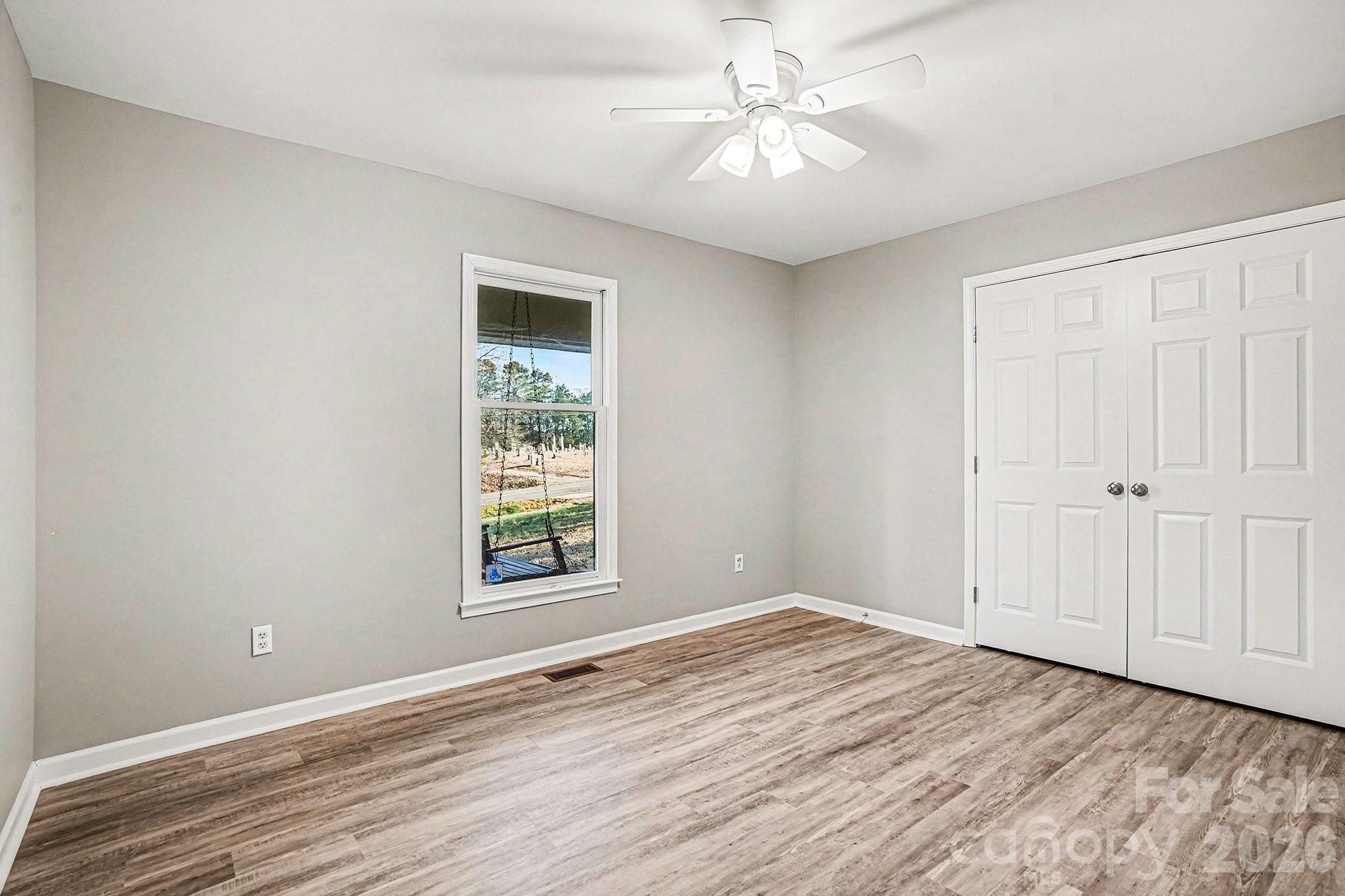 5509 Morgan Mill Road Monroe, NC 28110 - Photo 25 of 33 wooden floor in an empty room with a window