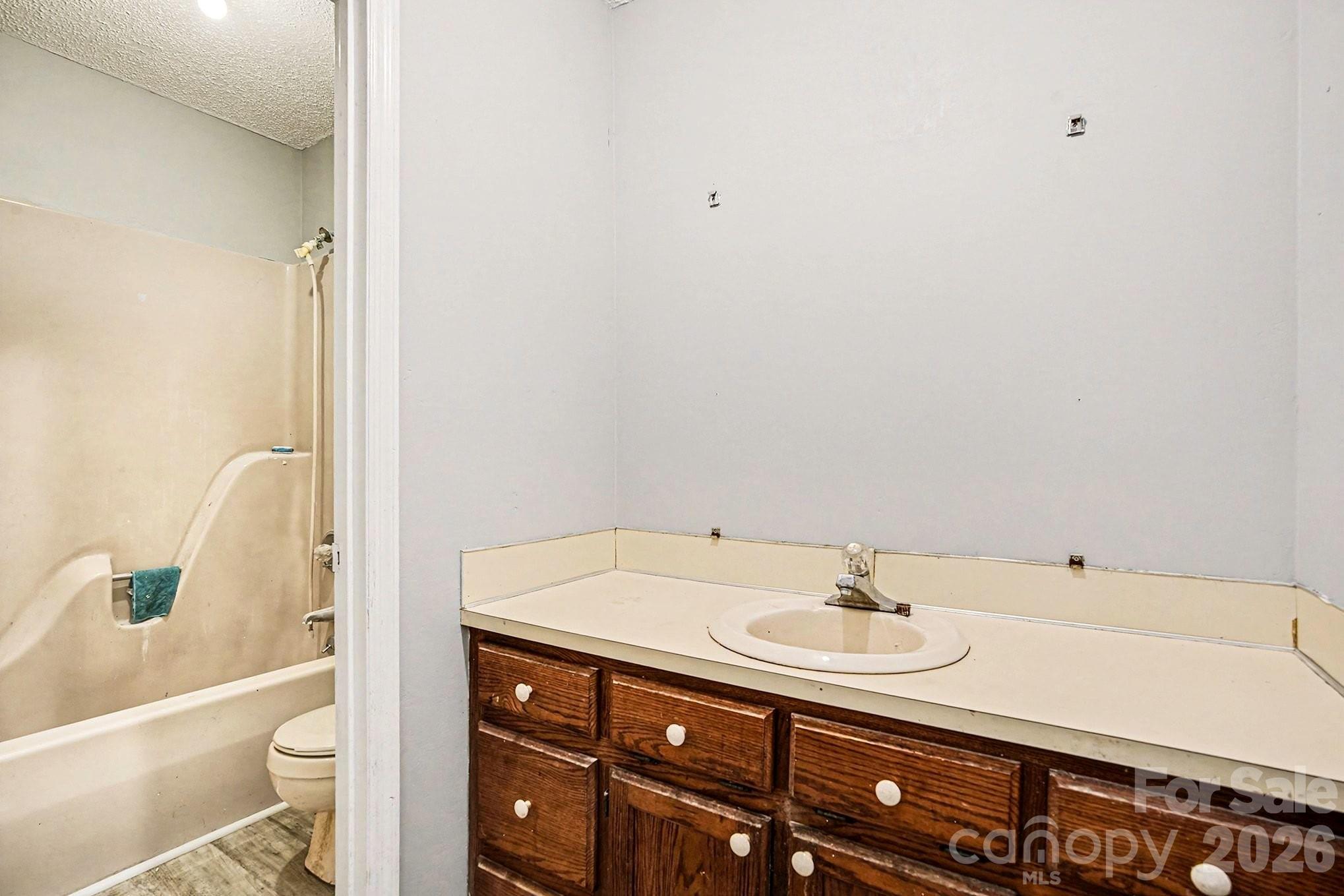 5509 Morgan Mill Road Monroe, NC 28110 - Photo 31 of 33 a bathroom with a sink a toilet and shower
