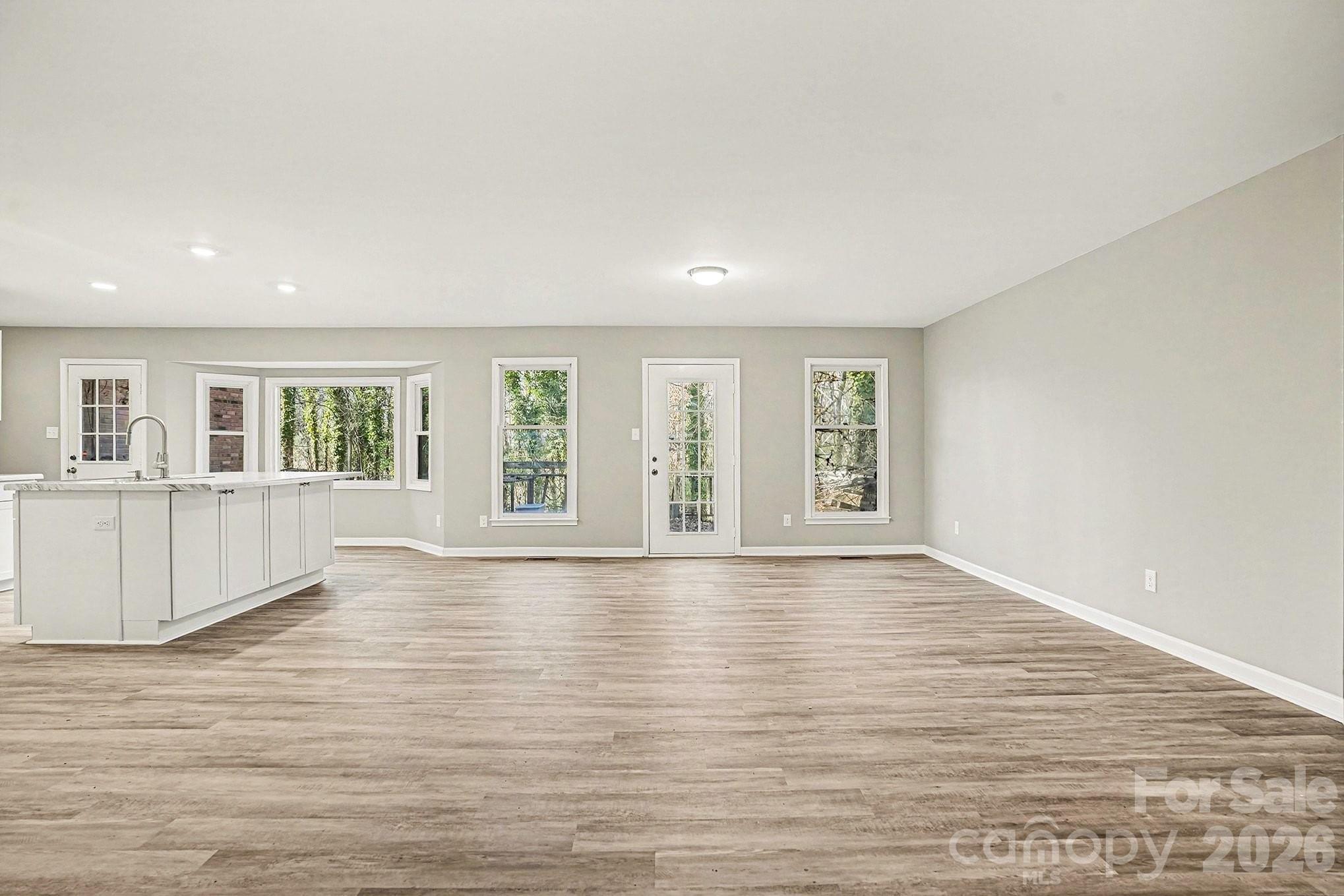 5509 Morgan Mill Road Monroe, NC 28110 - Photo 6 of 33 wooden floor in an empty room with a window