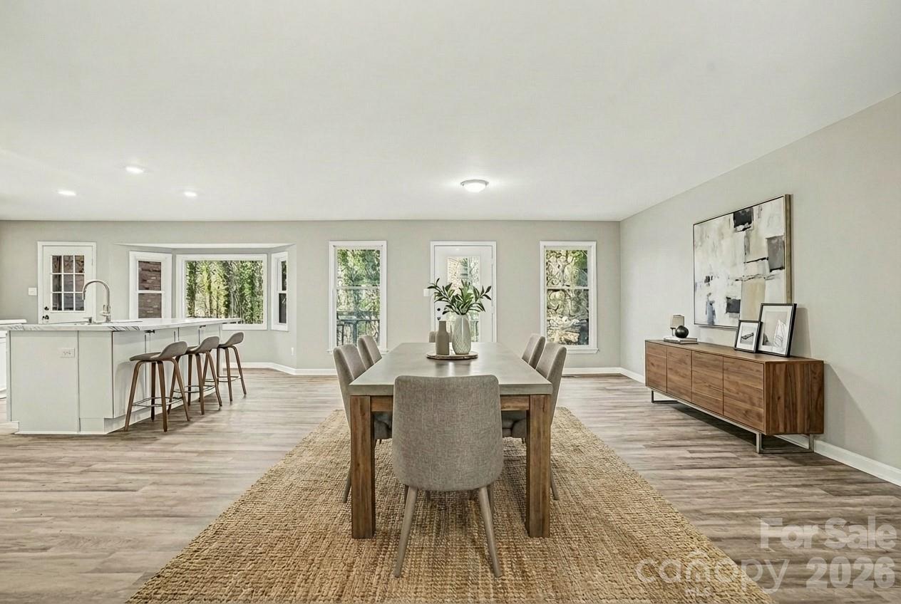 5509 Morgan Mill Road Monroe, NC 28110 - Photo 7 of 33 a view of a dining room with furniture and wooden floor