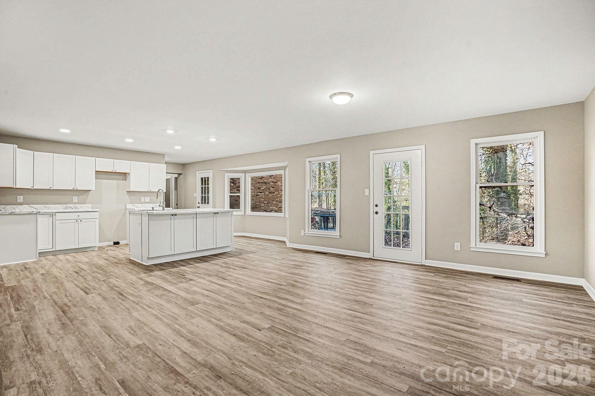 5509 Morgan Mill Road Monroe, NC 28110 - Photo 8 of 33 a view of an empty room with wooden floor and a window