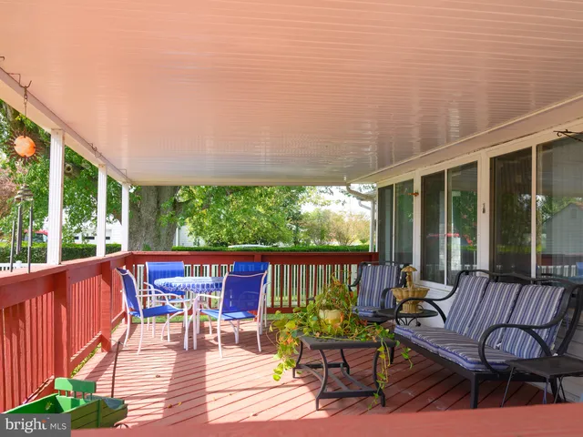 a view of a patio with a table chairs and a backyard