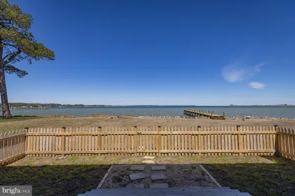 a view of a roof deck with wooden floor and fence