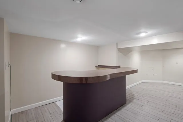 a bathroom with a toilet a sink a mirror and vanity