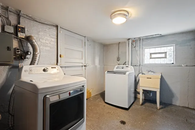a view of a storage and utility room with washer and dryer