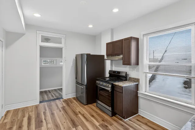 a kitchen with a refrigerator stove and microwave