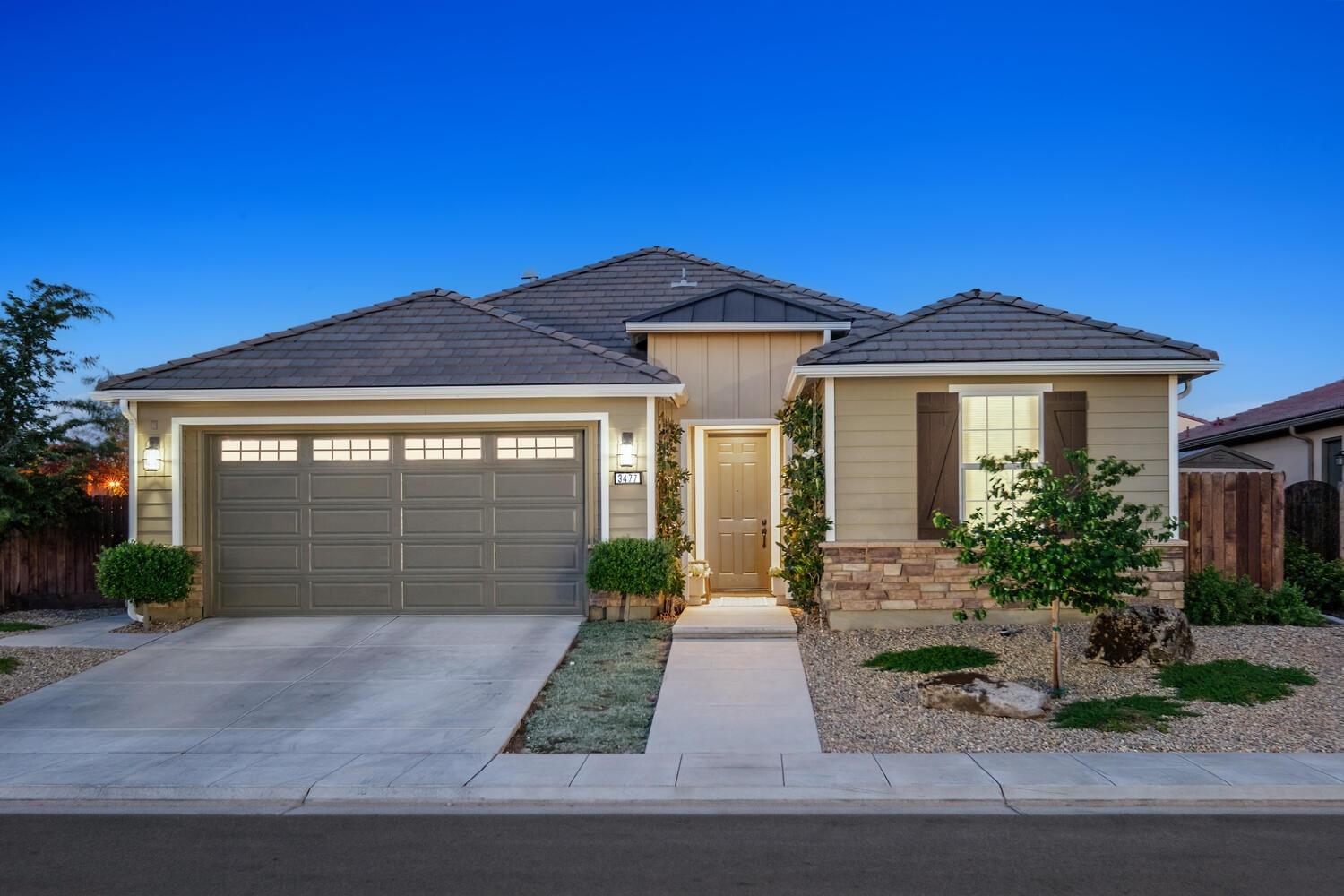 a front view of a house with garden