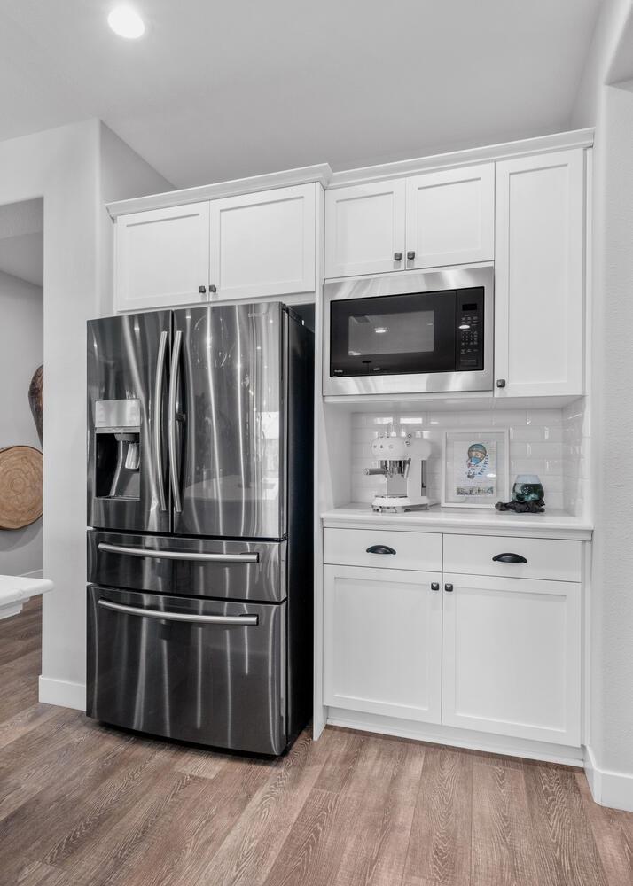3477 Junipero Avenue Clovis, CA 93619 - Photo 13 of 39 a kitchen with stainless steel appliances and white cabinets