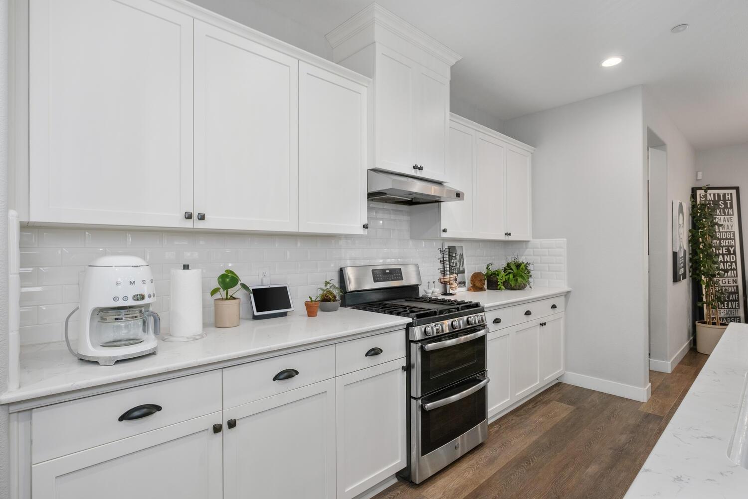 3477 Junipero Avenue Clovis, CA 93619 - Photo 14 of 39 a kitchen with stainless steel appliances granite countertop a sink a stove and cabinets