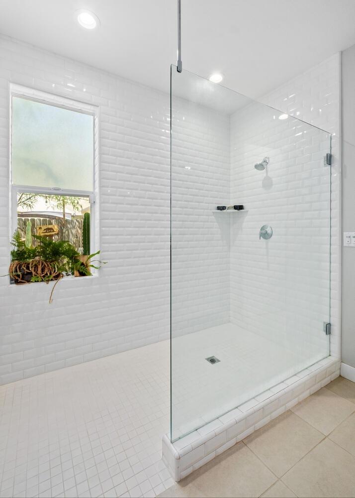 3477 Junipero Avenue Clovis, CA 93619 - Photo 20 of 39 a bathroom with a glass shower door
