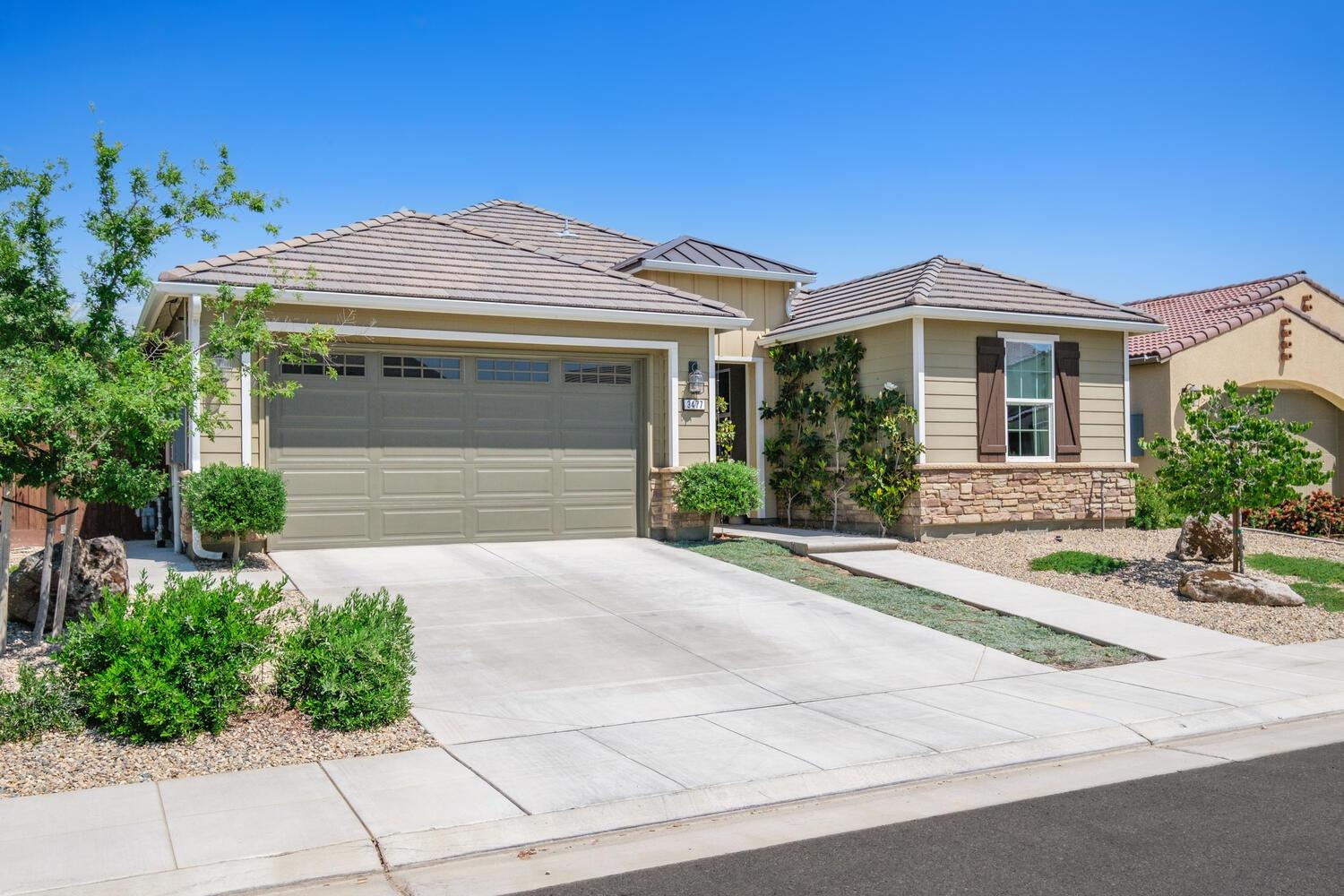 3477 Junipero Avenue Clovis, CA 93619 - Photo 2 of 39 a front view of a house with garden