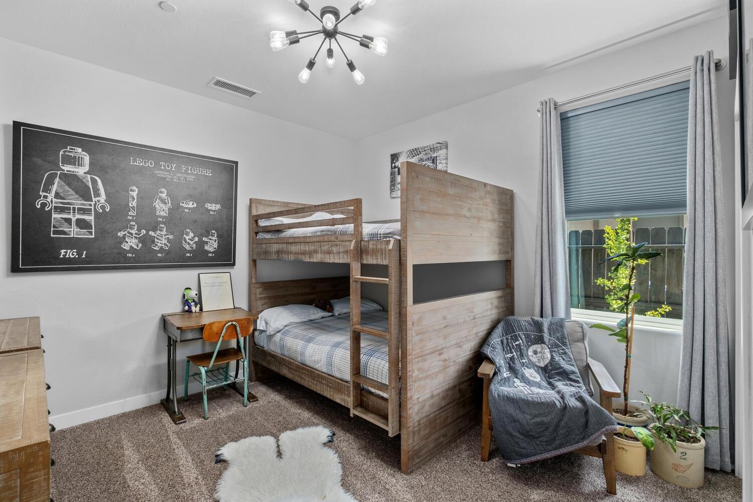 3477 Junipero Avenue Clovis, CA 93619 - Photo 22 of 39 a bedroom with a bed and a chandelier