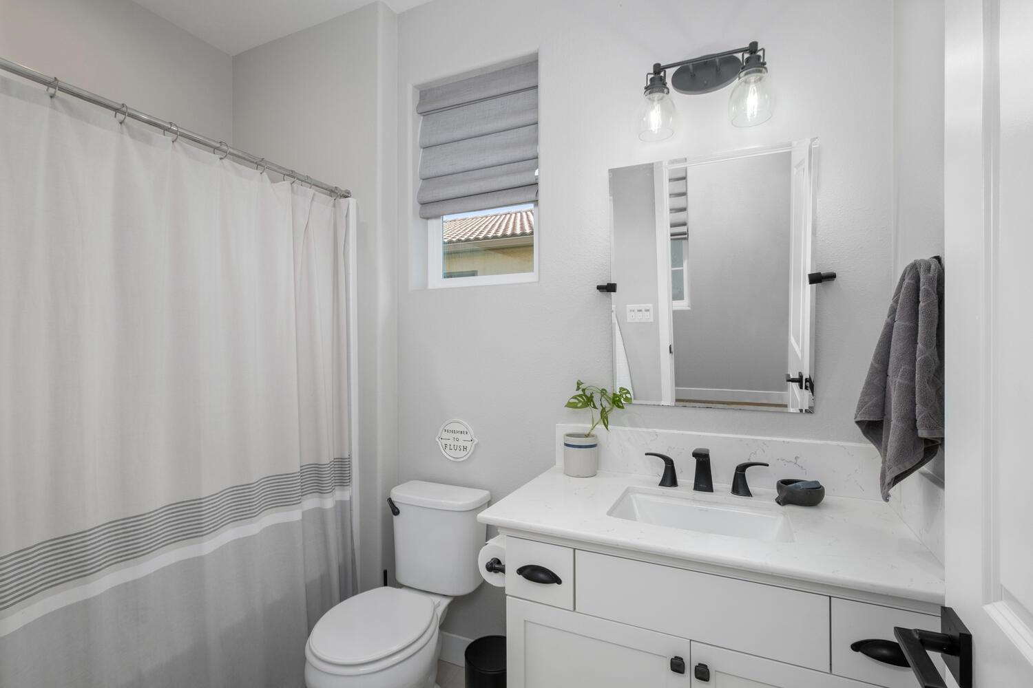 3477 Junipero Avenue Clovis, CA 93619 - Photo 23 of 39 a bathroom with a sink a toilet and shower