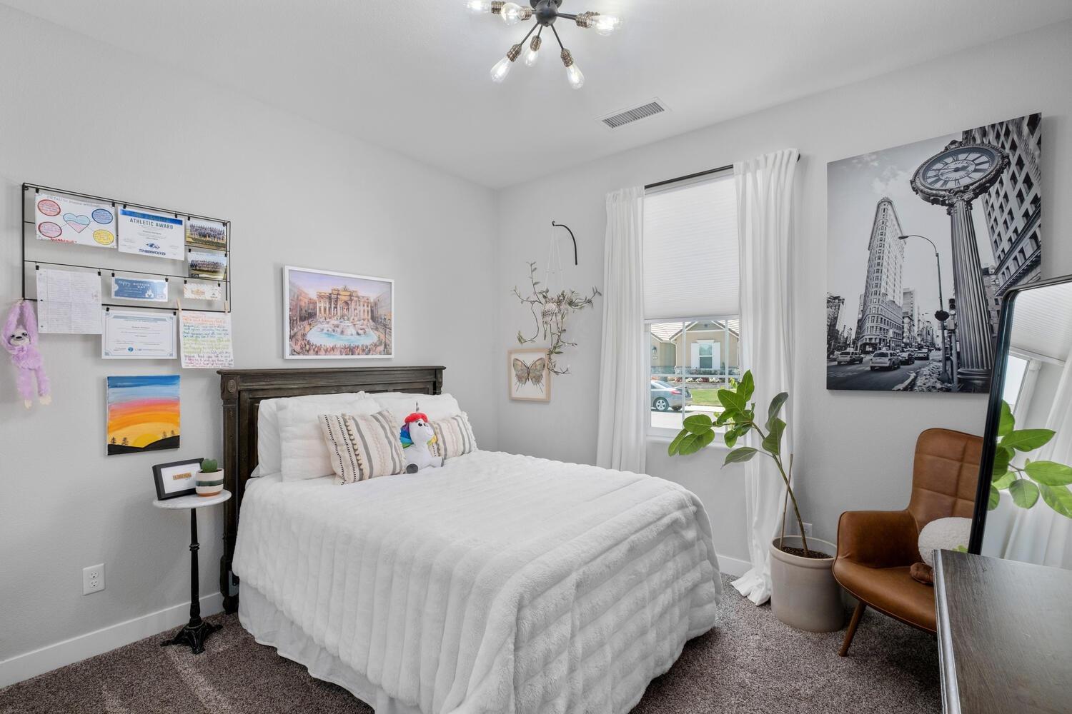 3477 Junipero Avenue Clovis, CA 93619 - Photo 24 of 39 a bedroom with bed and a chandelier