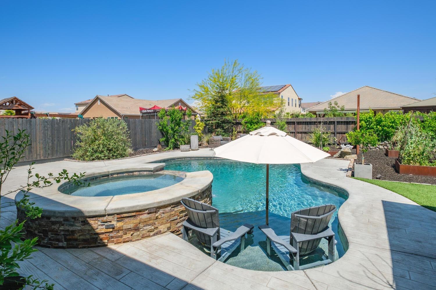 3477 Junipero Avenue Clovis, CA 93619 - Photo 27 of 39 a roof deck with table and chairs under an umbrella