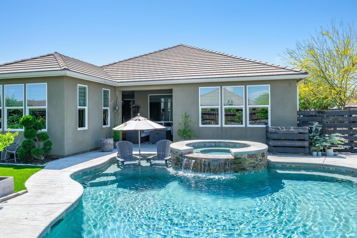 3477 Junipero Avenue Clovis, CA 93619 - Photo 28 of 39 a front view of a house with a yard table and chairs