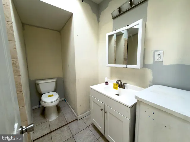 a bathroom with a sink toilet and a mirror