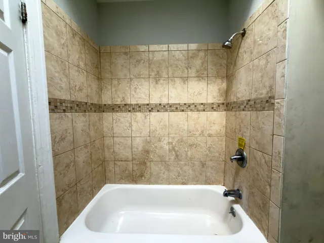 a bathroom with a shower and a bathtub