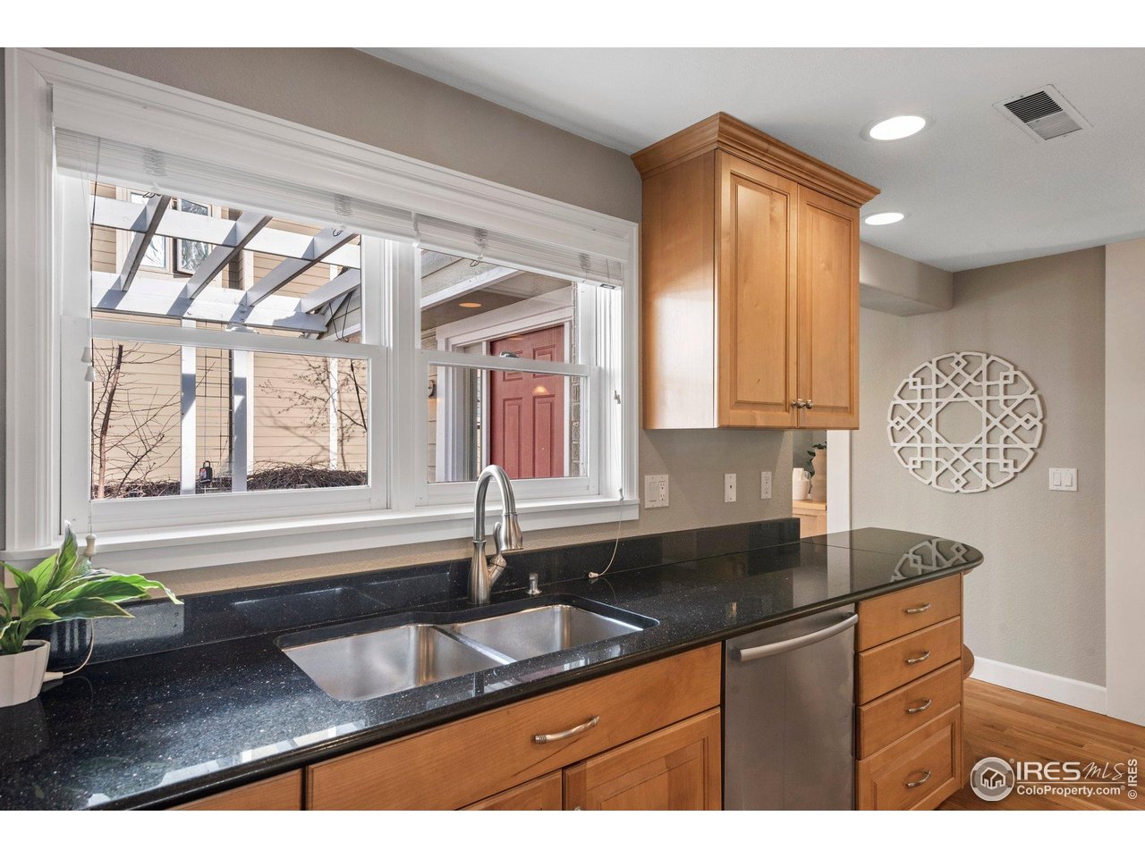 1490 Periwinkle Drive Boulder, CO 80304 - Photo 15 of 25 a kitchen with granite countertop a sink and a white wooden cabinets