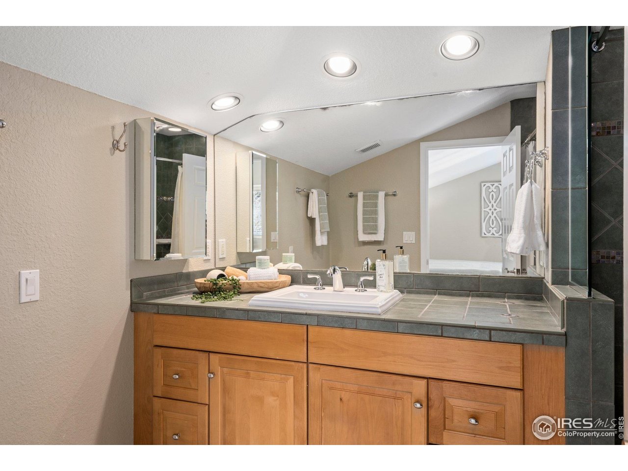 1490 Periwinkle Drive Boulder, CO 80304 - Photo 19 of 25 a bathroom with a sink double vanity and a mirror